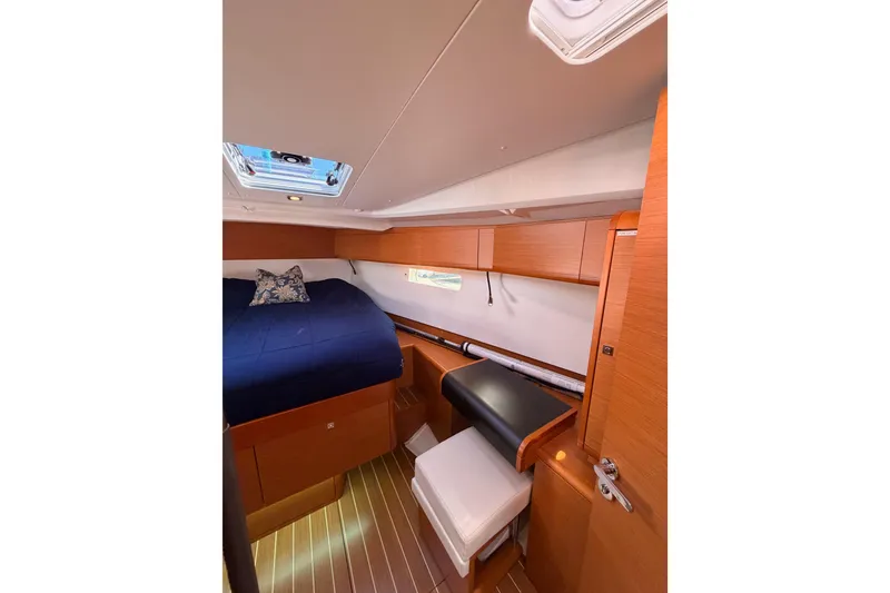 Slide: The Image of Interior cabin of 2014 Jeanneau Sun Odyssey 469, featuring wood finish and cozy bedding. - 83
