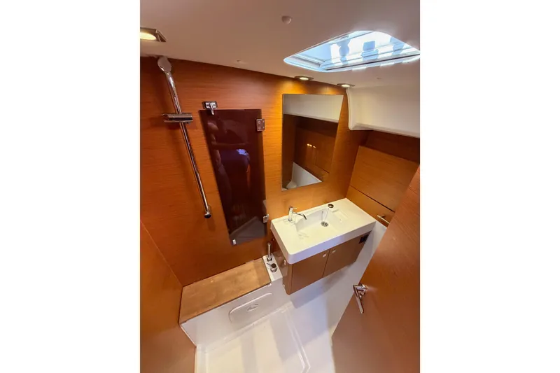Slide: The Image of Bathroom interior of 2014 Jeanneau Sun Odyssey 469 yacht, featuring modern fixtures and wood paneling. - 86