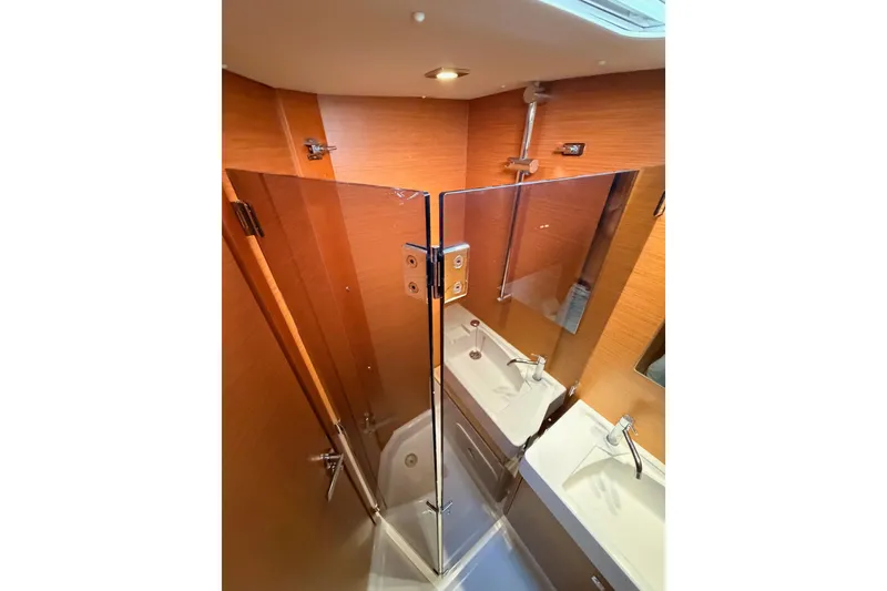 Slide: The Image of Bathroom interior of 2014 Jeanneau Sun Odyssey 469 yacht with modern fixtures and wood paneling. - 88
