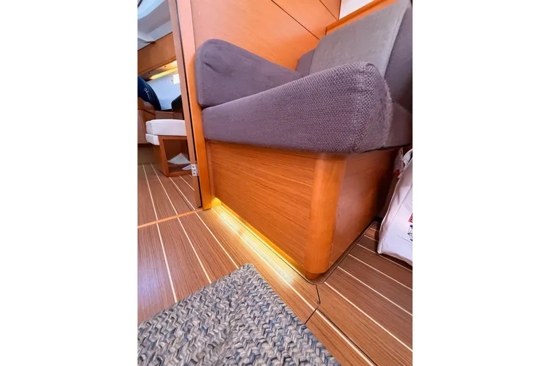 Slide: The Image of Interior of 2014 Jeanneau Sun Odyssey 469 yacht with wooden flooring and cushioned seating. - 96