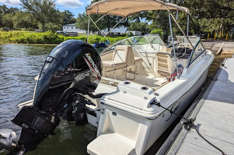 Slide: The Image of 2022 Scout 210 Dorado boat docked with Mercury outboard engine. - 7