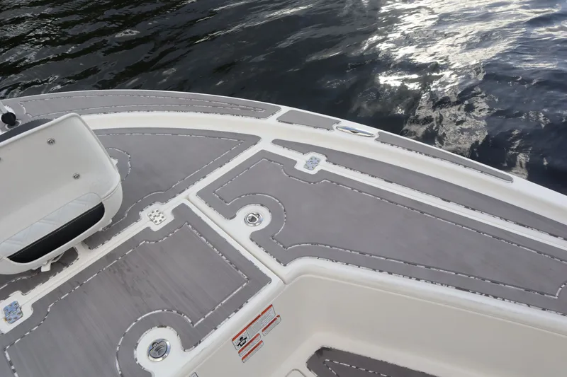 Slide: The Image of Deck of a 2019 Mako 21 LTS boat on water. - 15