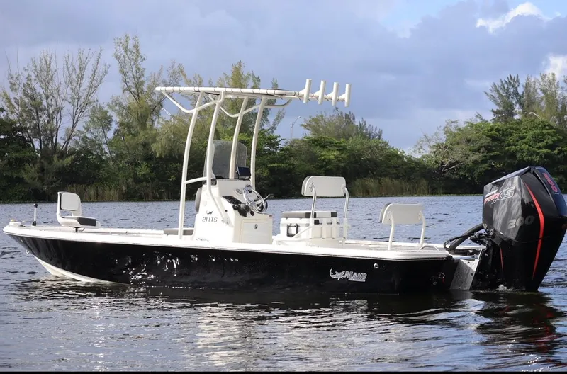 Slide: The Image of 2019 Mako 21 LTS boat on calm water. - 16