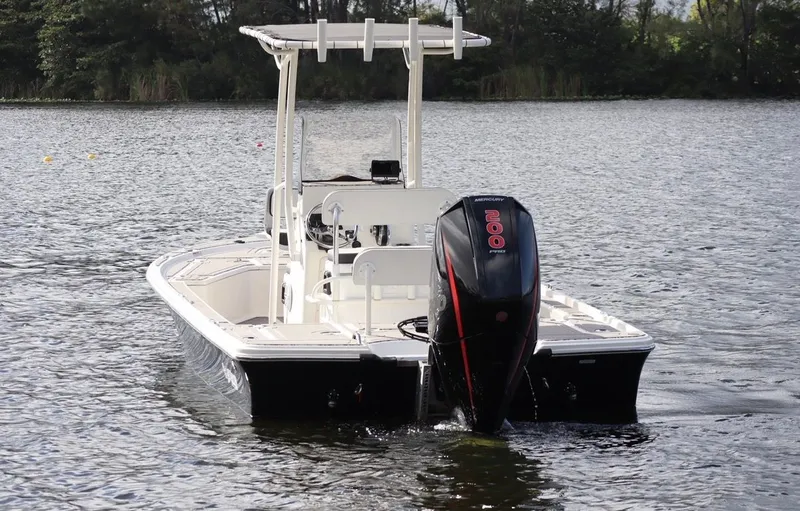 Slide: The Image of 2019 Mako 21 LTS boat on a calm lake. - 17