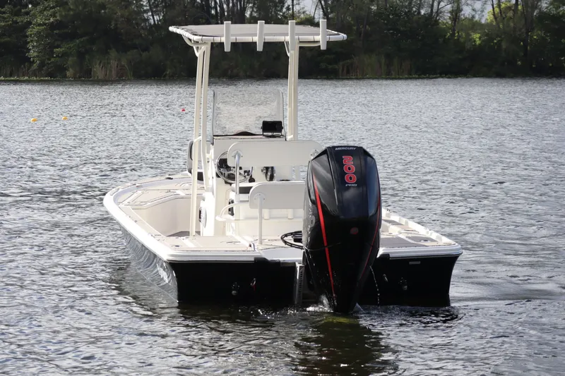 Slide: The Image of 2019 Mako 21 LTS boat on calm water. - 2