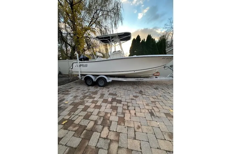 The Image of 2023 Mako 214 Center Console boat on trailer, parked on paved driveway. - 0