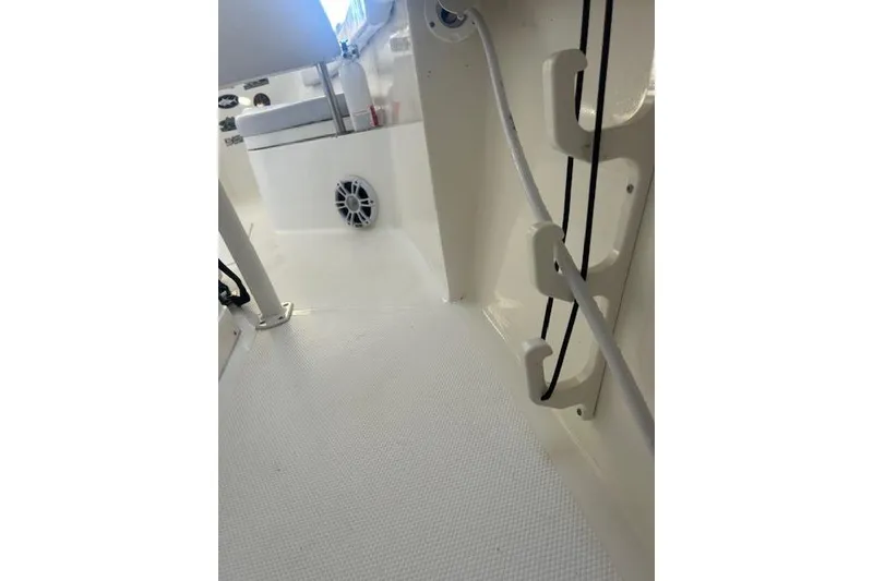 Slide: The Image of 2023 Mako 214 Center Console interior with rod holders and speaker. - 1