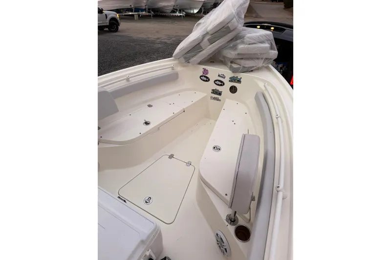 Slide: The Image of 2023 Mako 214 Center Console boat interior with seating and storage compartments. - 10