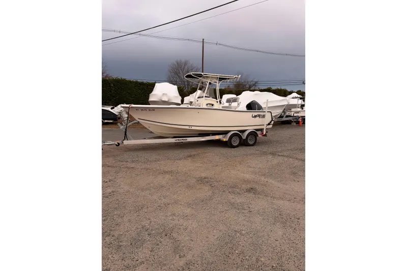 Slide: The Image of 2023 Mako 214 Center Console boat on trailer in outdoor storage area. - 11