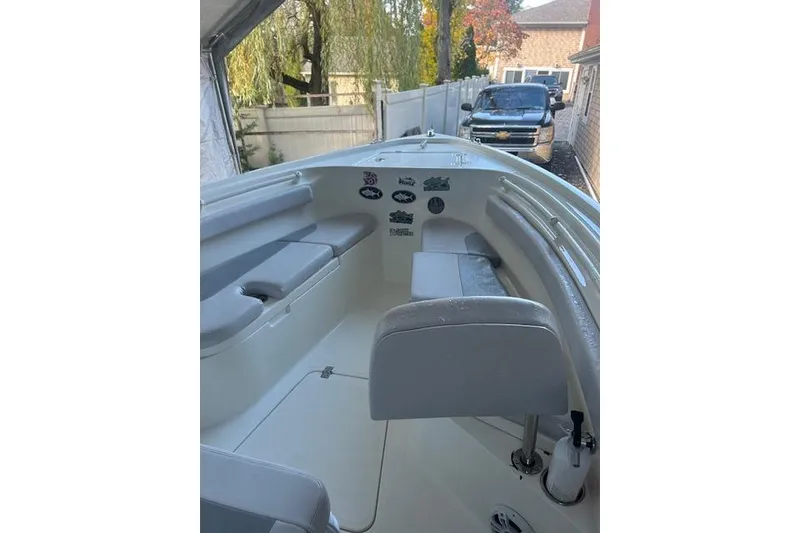 Slide: The Image of 2023 Mako 214 Center Console boat interior with seating and decals. - 8