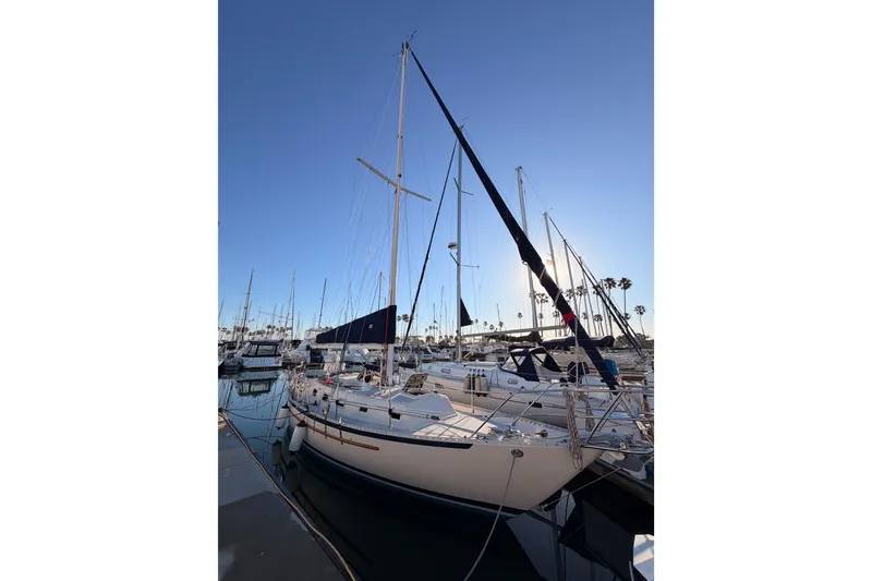 Slide: The Image of Sailboat docked at marina, Pacific Seacraft 34, 1995 model, under clear blue sky. - 1