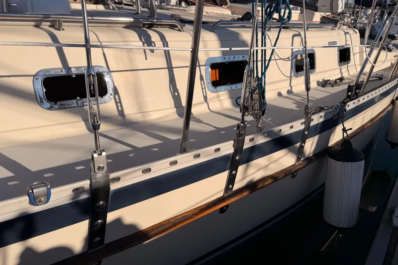 Slide: The Image of 1995 Pacific Seacraft 34 sailboat, detailed deck view with rigging and portholes. - 11