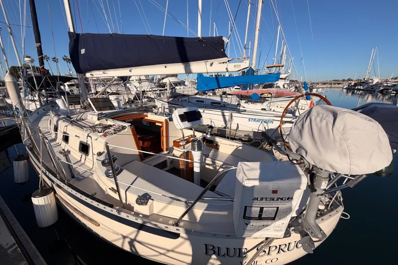 Slide: The Image of Sailboat docked in marina, Pacific Seacraft 34, 1995 model, with blue sail cover. - 15