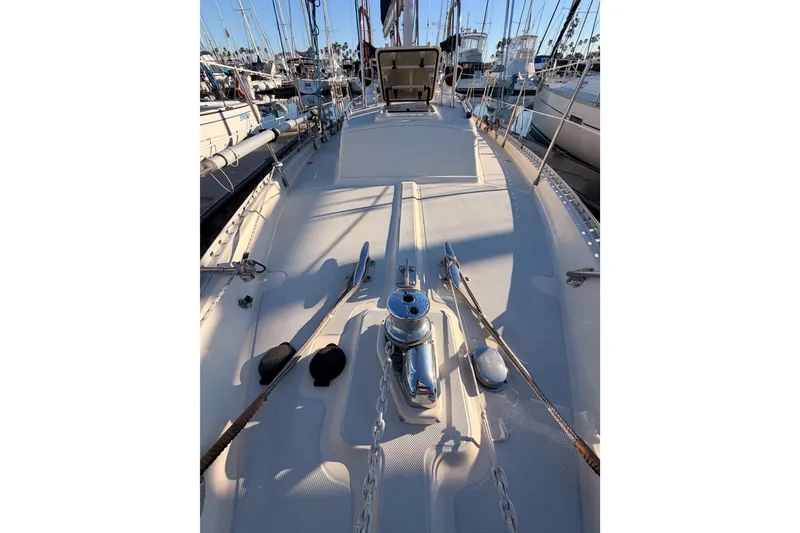 Slide: The Image of Deck view of a 1995 Pacific Seacraft 34 sailboat in a marina. - 23