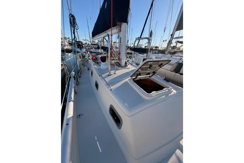 Slide: The Image of 1995 Pacific Seacraft 34 sailboat deck with open hatch in marina. - 25