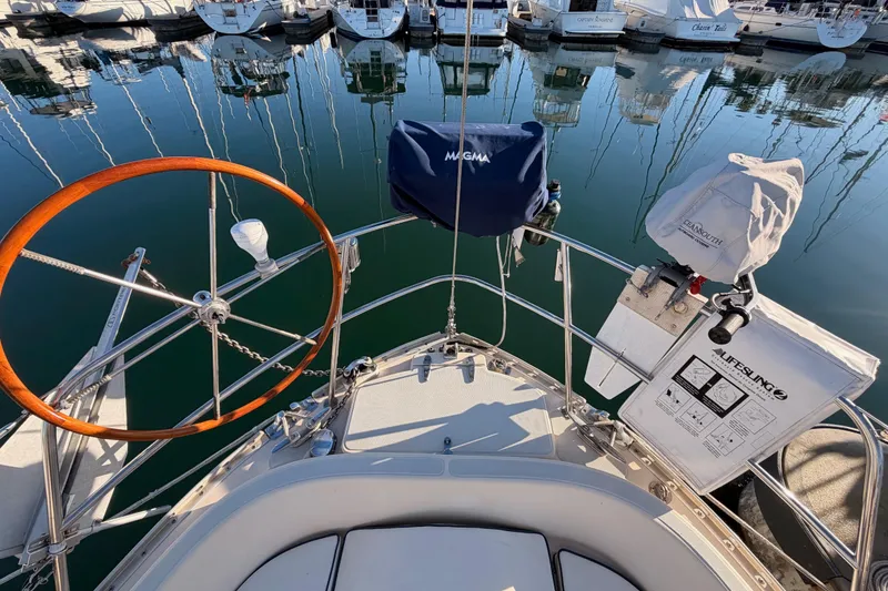 Slide: The Image of Cockpit view of a 1995 Pacific Seacraft 34 sailboat docked in a marina. - 32