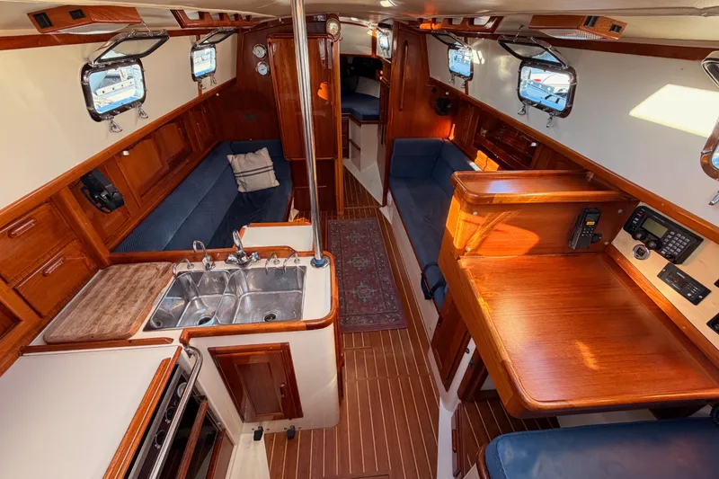 Slide: The Image of Interior of 1995 Pacific Seacraft 34 sailboat with wood finish and compact kitchen. - 38