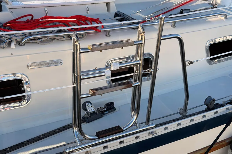 Slide: The Image of Stainless steel ladder on 1995 Pacific Seacraft 34 sailboat deck with ropes. - 4