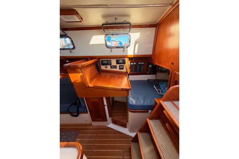 Slide: The Image of Interior of 1995 Pacific Seacraft 34 sailboat with wooden finish and navigation station. - 47