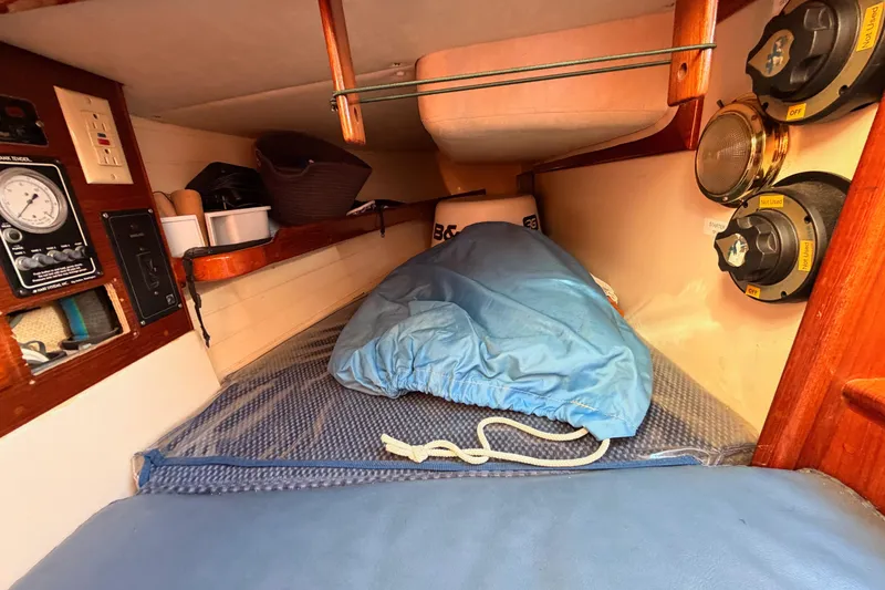 Slide: The Image of Cozy cabin interior of 1995 Pacific Seacraft 34 sailboat with storage and control panel. - 49