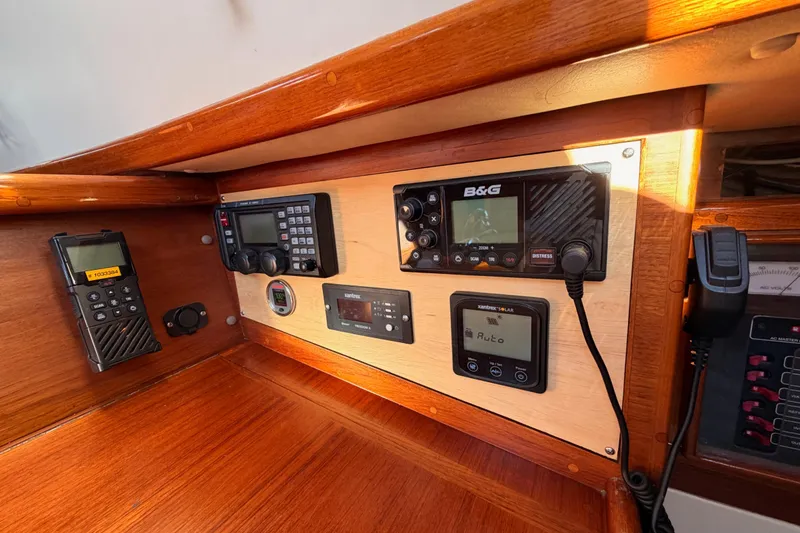 Slide: The Image of Navigation equipment on a 1995 Pacific Seacraft 34 sailboat, featuring radios and control panels. - 51