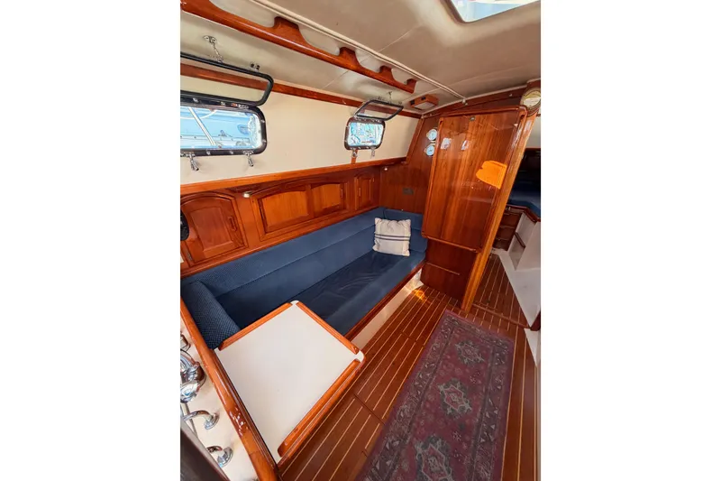 Slide: The Image of Interior of 1995 Pacific Seacraft 34 sailboat with wooden finish and blue seating. - 54