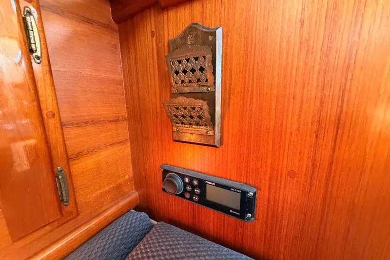 Slide: The Image of Interior of 1995 Pacific Seacraft 34 with wooden paneling and vintage metal vent. - 57