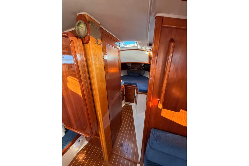 Slide: The Image of Interior of 1995 Pacific Seacraft 34 sailboat with wooden finish and cozy seating. - 62