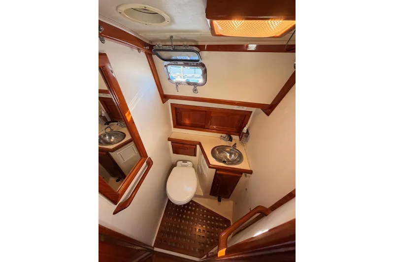 Slide: The Image of Bathroom interior of 1995 Pacific Seacraft 34 sailboat, featuring wood accents and compact design. - 66
