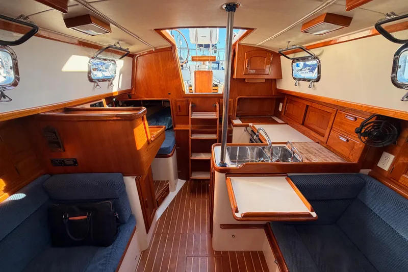 Slide: The Image of Interior of 1995 Pacific Seacraft 34 sailboat with wood finish and compact kitchen. - 69