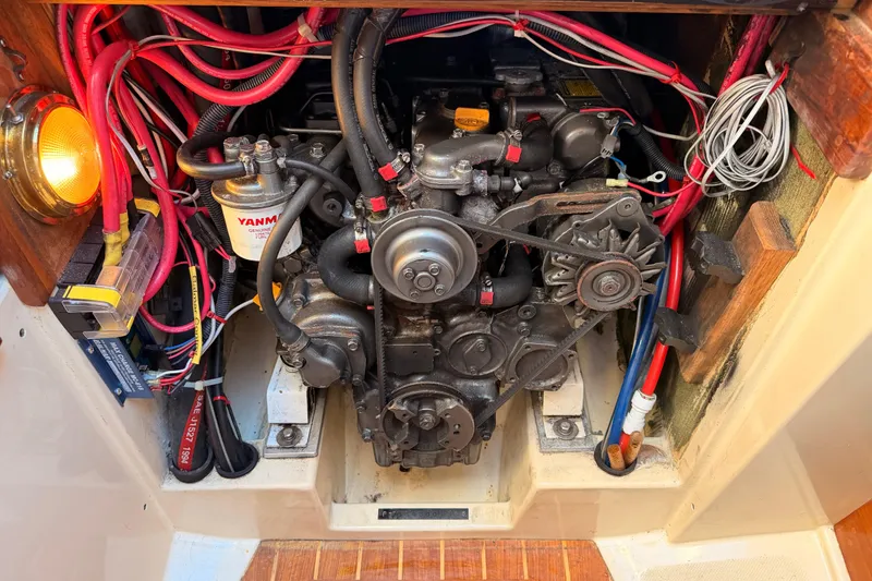 Slide: The Image of Engine compartment of a 1995 Pacific Seacraft 34 sailboat, featuring a Yanmar diesel engine. - 72