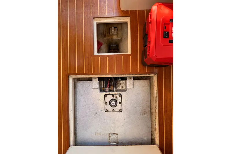 Slide: The Image of 1995 Pacific Seacraft 34 interior with wooden flooring and storage compartments. - 74