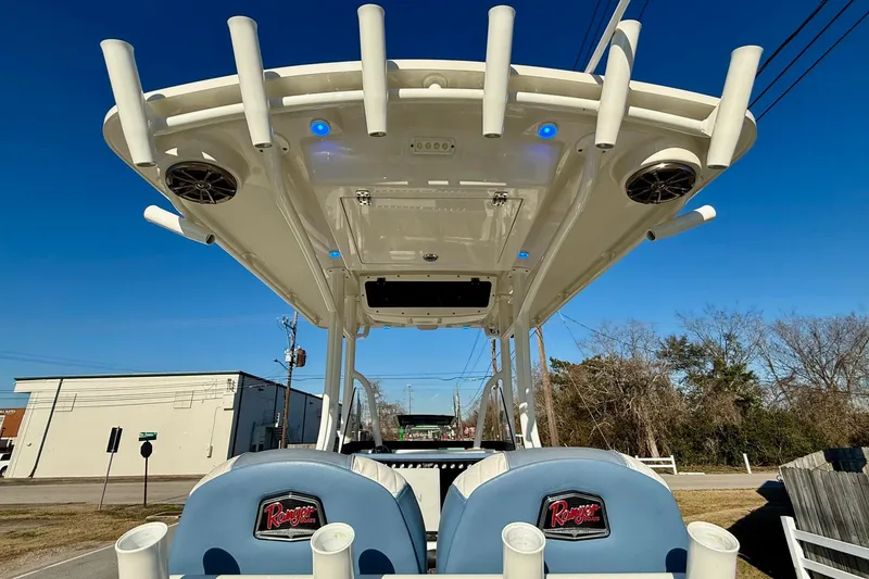 Slide: The Image of 2022 Ranger 2510 Bay boat with T-top and rod holders under clear blue sky. - 12