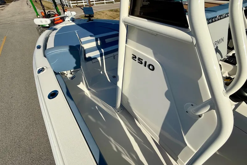 Slide: The Image of 2022 Ranger 2510 Bay boat, white interior, blue seating, Garmin equipment visible. - 13