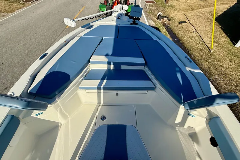 Slide: The Image of 2022 Ranger 2510 Bay boat with blue seating and Garmin equipment on deck. - 14