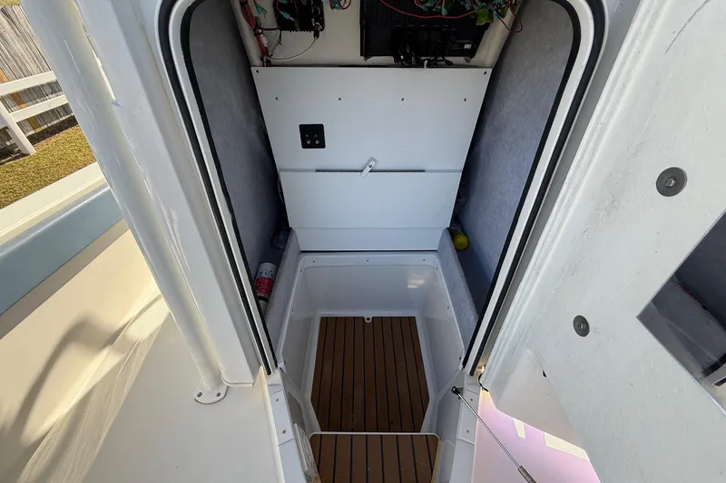 Slide: The Image of Interior view of 2022 Ranger 2510 Bay boat compartment with wooden flooring. - 24