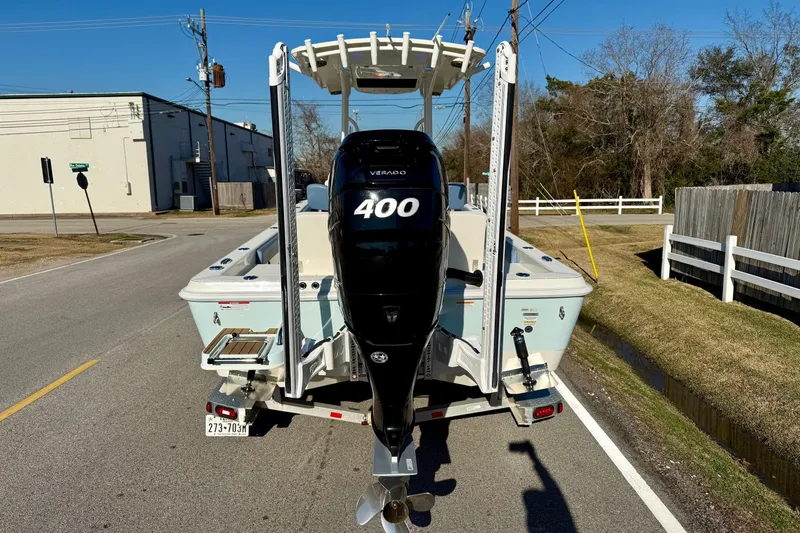 Slide: The Image of 2022 Ranger 2510 Bay boat with Verado 400 engine on a street. - 3