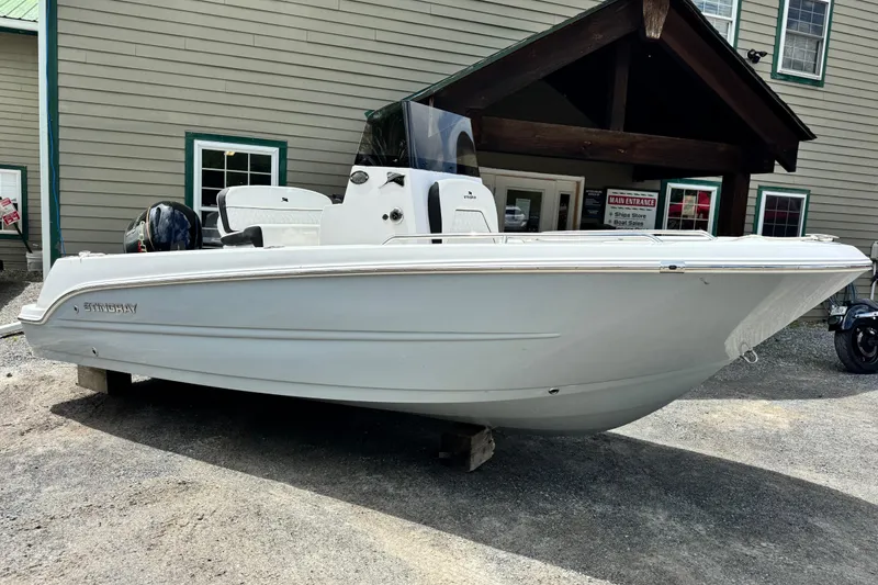 The Image of 2026 Stingray 173 CC boat displayed outdoors near a building. - 0