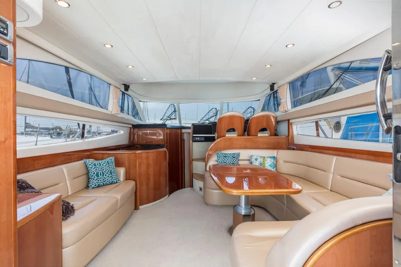 Slide: The Image of Luxurious interior of a 2007 Viking Sport Cruiser yacht with elegant seating and dining area. - 13