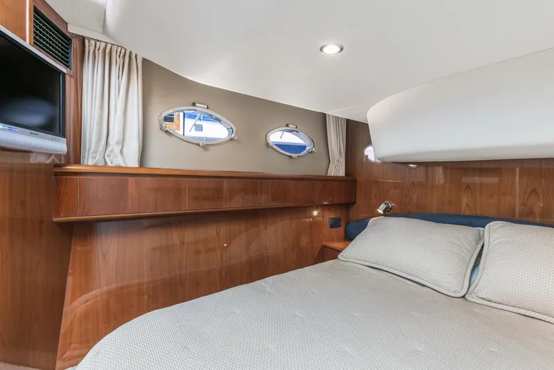 Slide: The Image of Luxurious cabin interior of a 2007 Viking Sport Cruiser yacht with elegant wood finish. - 25
