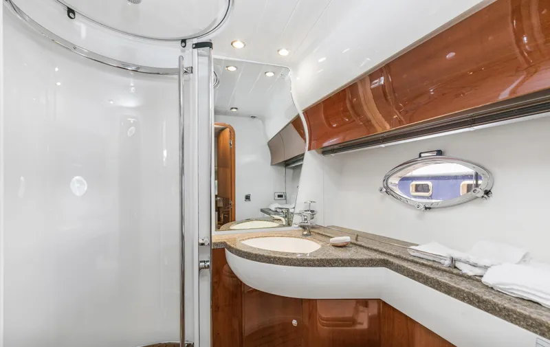 Slide: The Image of Luxurious bathroom in 2007 Viking Sport Cruiser with modern fixtures and elegant wood accents. - 30