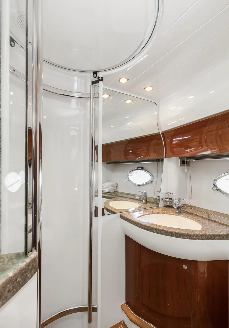 Slide: The Image of Luxurious bathroom in 2007 Viking Sport Cruiser with modern fixtures and elegant wood accents. - 31