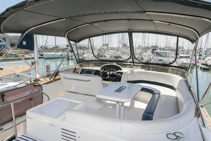 Slide: The Image of 2007 Viking Sport Cruiser yacht interior with helm, seating, and marina view. - 34
