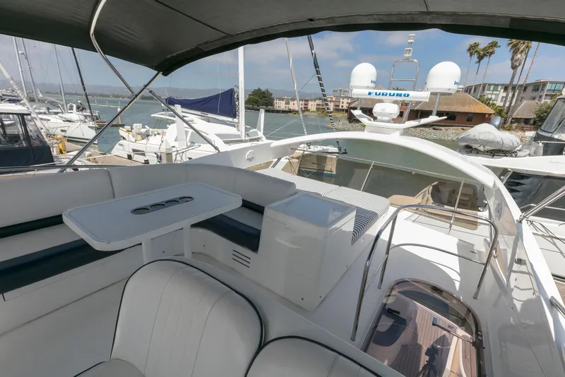 Slide: The Image of 2007 Viking Sport Cruiser yacht interior with seating and table, docked at marina. - 35