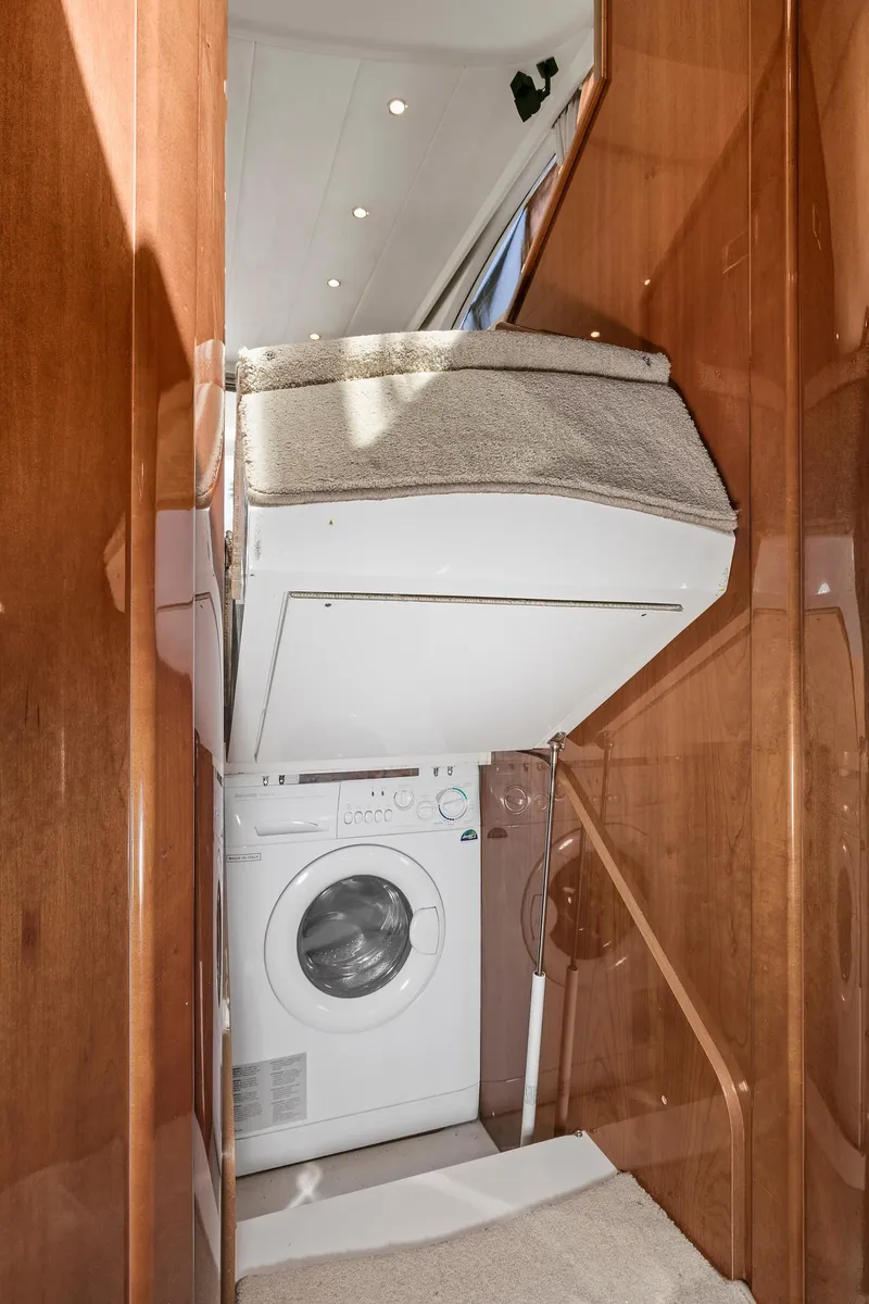 Slide: The Image of 2007 Viking Sport Cruiser interior with washing machine and wooden cabinetry. - 42
