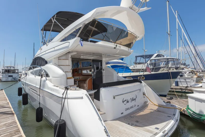Slide: The Image of 2007 Viking Sport Cruiser yacht docked at marina, featuring sleek design and spacious deck. - 49
