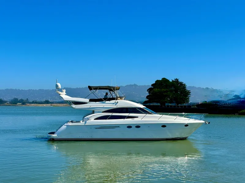 Slide: The Image of 2007 Viking Sport Cruiser yacht on calm water under clear blue sky. - 8
