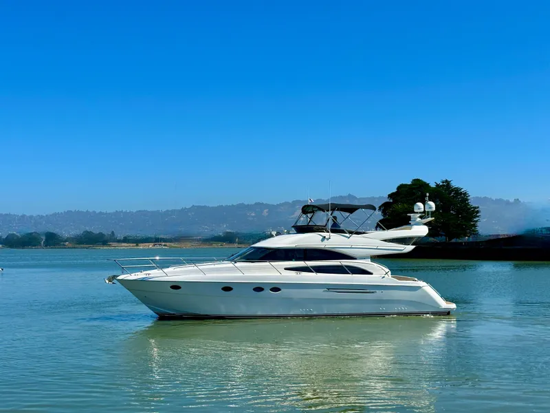 Slide: The Image of 2007 Viking Sport Cruiser yacht on calm water under clear blue sky. - 9