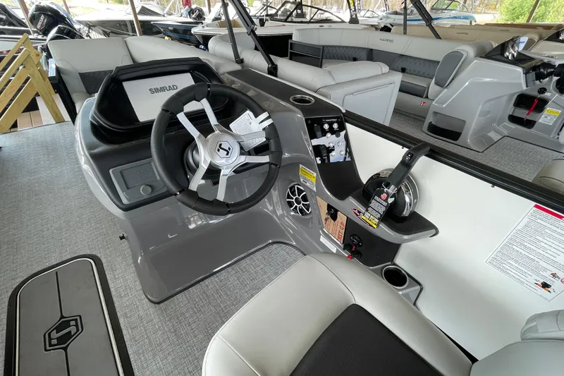 Slide: The Image of 2026 Harris Sunliner 230 boat interior with steering wheel and control panel. - 12