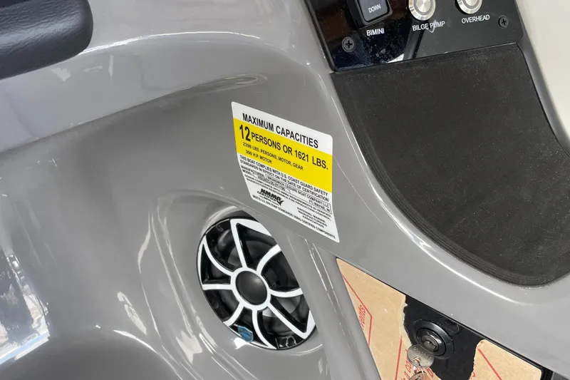 Slide: The Image of 2026 Harris Sunliner 230 boat dashboard with capacity label and speaker detail. - 14